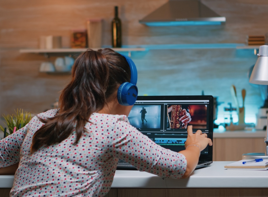 Video editor wearing headset and working from home